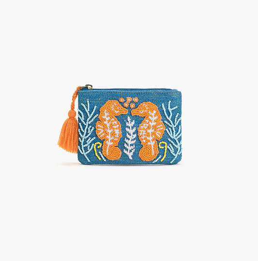 Blue pouch with orange floral design and tassel on a white background