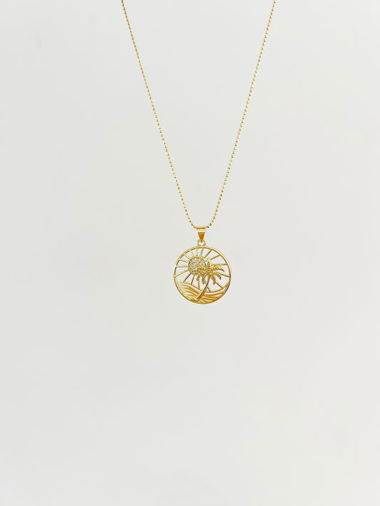 Gold Island time palm tree, sun, and wave necklace